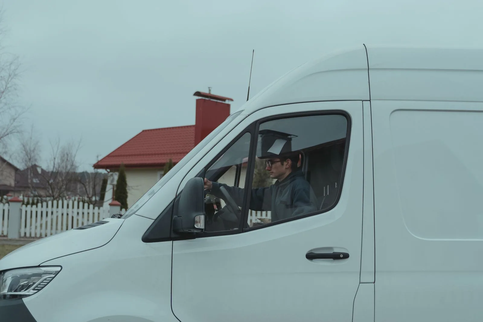 A technician in a service van on a residential street